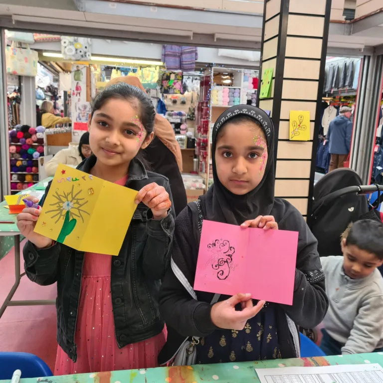Girls with Eid cards made in Keighley Market workshop