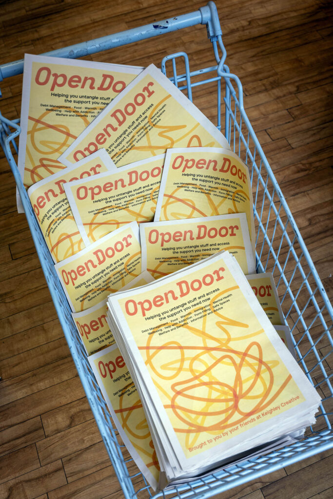 Open Door newspapers in a shopping trolley