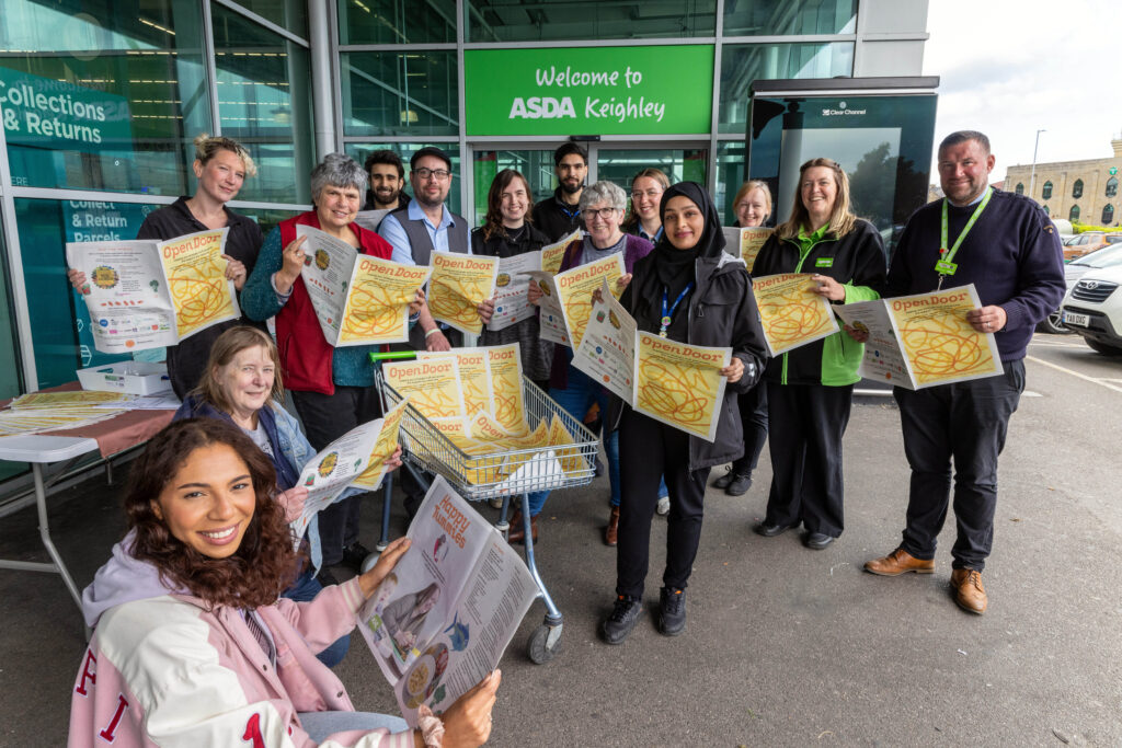 Open Door newspaper being given away from Asda Keighley