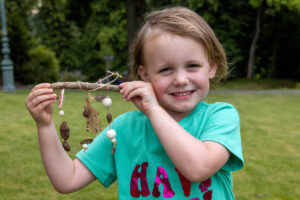 Child with their nature creation made with Keighley Creative